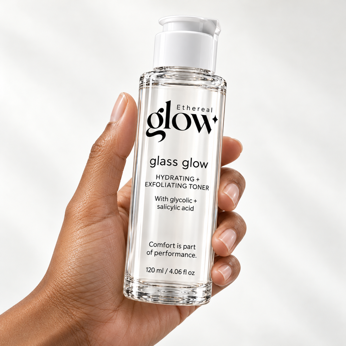 Illustrative studio image of the Glass Glow 120 ml toner packaging concept held in one hand.